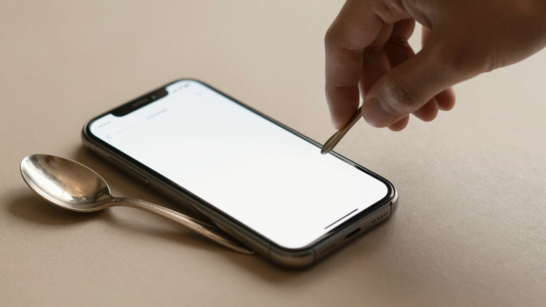 Phone using Google Lens next to a dedicated antique identifier app on an old silver piece